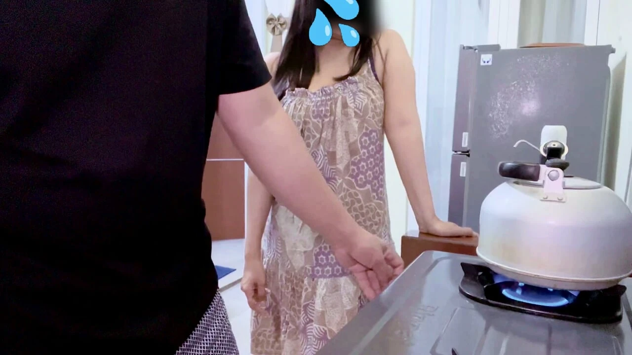 Boarding house woman approaches boarding house residents in the kitchen