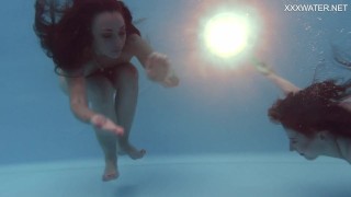 Girlfriends enjoy swimming naked together